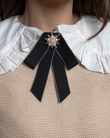 Spilla fiocco nera con bordo oro